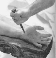 The nail going into Christ's hand